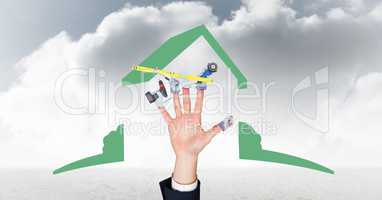 Digital composite image of hand with tools  against cloudy sky