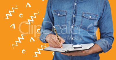 Man denim shirt mid section with notebook against orange background with white patterns