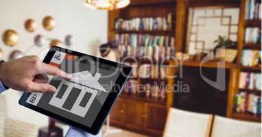 Hand using smart home application on digital tablet