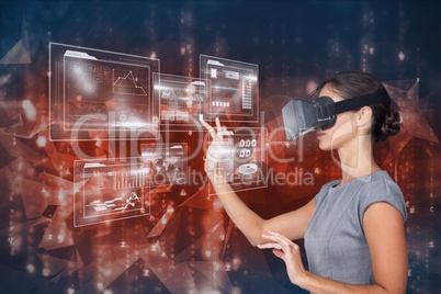 Digital composite image of woman touching futuristic screen while using VR glasses