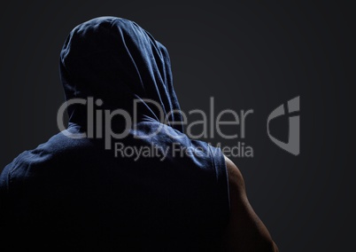 Back of man with hoodie against dark grey background