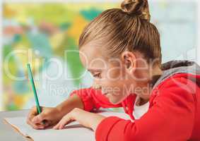 Girl doing homework against blurry map
