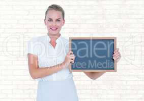 Business woman with blackboard with wall background