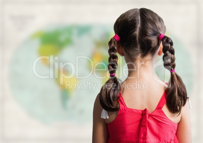Back of girl with braids against blurry map