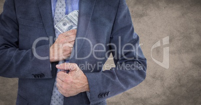 Business man mid section putting money away against brown grunge background