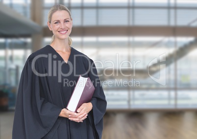 Judge holding book in front of windows