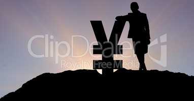 Silhouette businesswoman leaning on yen sign against sky