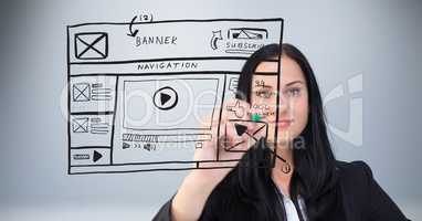 Businesswoman drawing mock ups of website