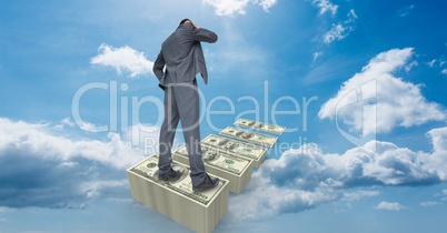 Digital composite image of businessman standing on banknotes in sky