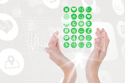 Digital composite image of hand covering various icons against tech graphics