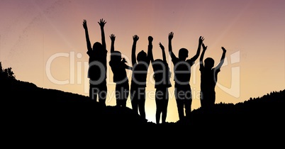 Silhouette children with hands raised on mountain during sunset