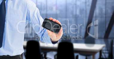 Midsection of businessman showing smart phone with blank screen