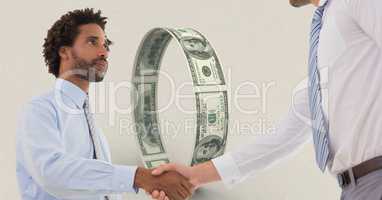 Businessmen shaking hands money in background