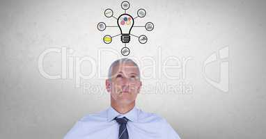 Digital composite image of businessman with light bulb graphics