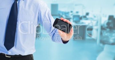 Midsection of businessman showing blank screen on mobile phone