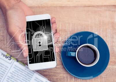 Overhead of hand with phone and tea and lock graphic and flare