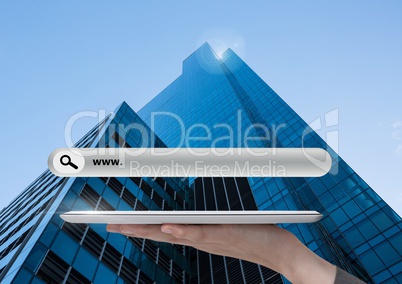 Hand holding tablet with Search Bar with skyscraper background