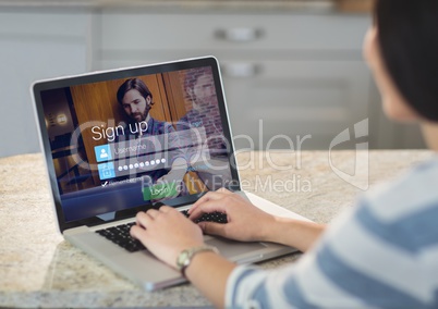 Woman on the table of the kitchen with laptop. Login screen
