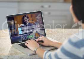 Woman on the table of the kitchen with laptop. Login screen