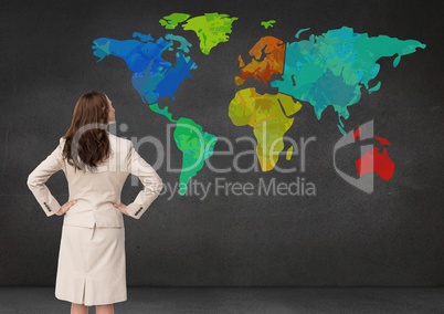 Businesswoman looking at Colorful Map on wall background