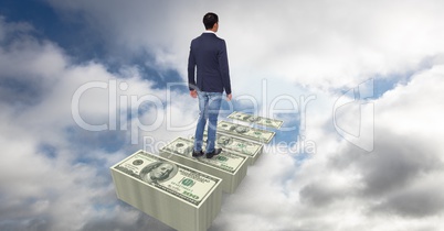 Digital composite image of businessman walking on dollar steps in sky