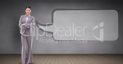Businesswoman standing arms crossed by speech bubble
