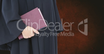 Midsection of judge holding book