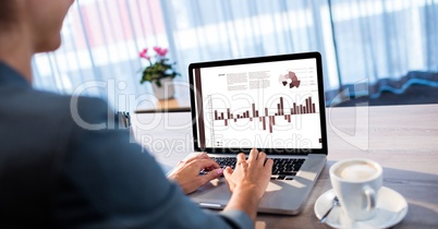 Cropped image of woman preparing graphs on laptop in office