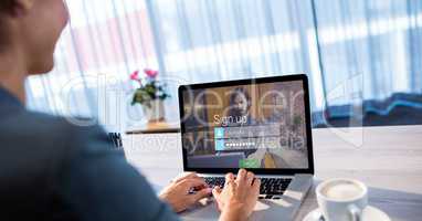 Businesswoman signing up on site using laptop