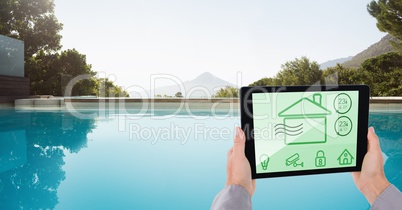 Hands using smart home app at poolside