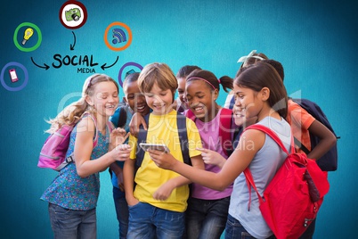 Digital composite image of school students looking at smart phone with various icons against blue ba