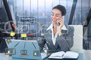 Digital composite image of happy businesswoman using smart phone and laptop with icons in foreground