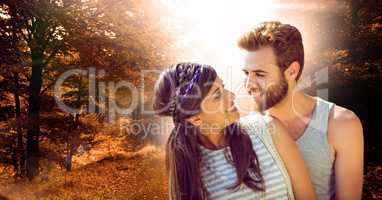 Loving couple smiling in forest during autumn