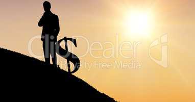 Silhouette businessman with dollar sign against sky during sunset