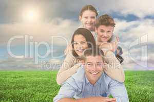 Happy family lying on each other at park