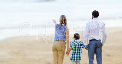 Rear view of parents with children on beach