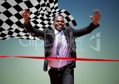 Business man reaching finish line against blue green background and checkered flag
