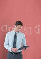 Businessman holding digital tablet over colored background