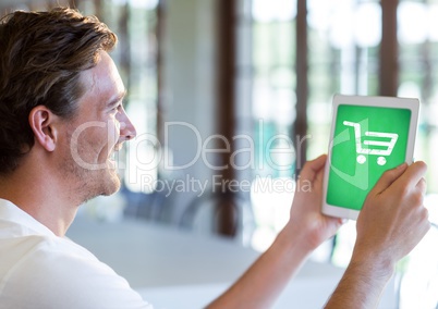 Man holding Tablet with Shopping trolley icon