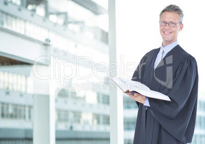 Judge holding book in front of building