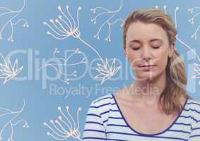 Woman with eyes closed against blue background with white floral pattern