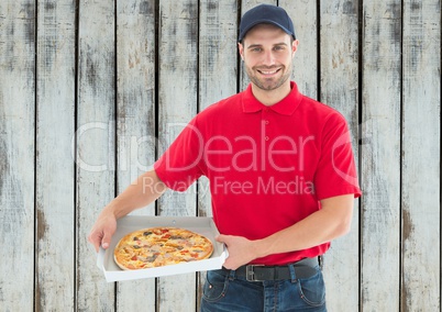Happy deliveryman with pizza. Wood background