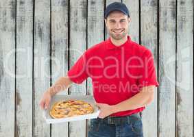 Happy deliveryman with pizza. Wood background