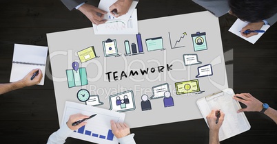 Teamwork text by icons and business people on table