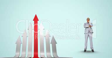 Businessman standing by red and gray arrows