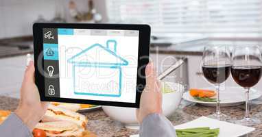 Hands using smart home app on digital tablet
