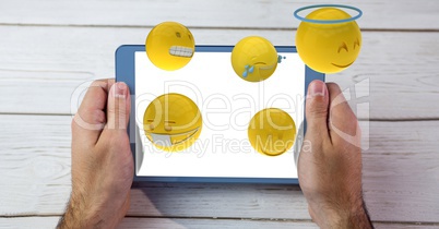 Emojis flying out from tablet PC held by man