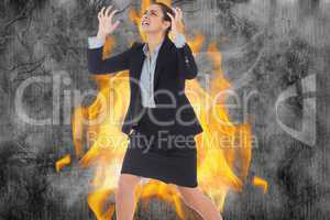 Angry businesswoman gesturing against fire