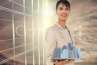 Composite image of woman holding buildings in 3d