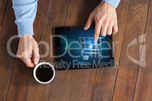 top view of man working tablet with shopping cart on screen